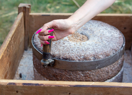 A girl grinds flour from a stone to marry.