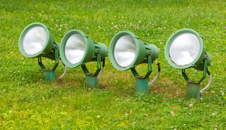 Spotlights on the green lawn during the day.の写真素材
