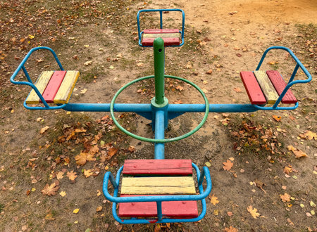 Swings on the playground in autumn.の写真素材