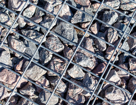 Stones under a metal grate. Background.の写真素材