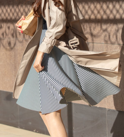 A girl with bread in her hands walks in the city.の写真素材