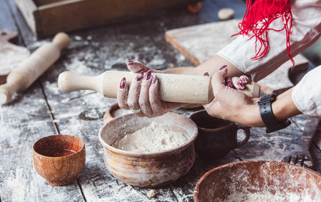 Rolling pin with flour on a wooden table.の写真素材