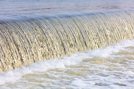 Waterfall on the river in winter as a background.の写真素材