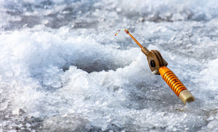Fishing rod on ice in winter. Ice fishing.の写真素材