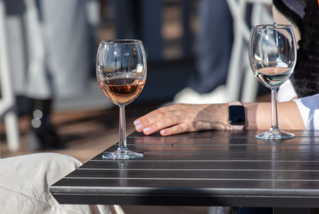 A glass of champagne on a table in a cafe.の写真素材