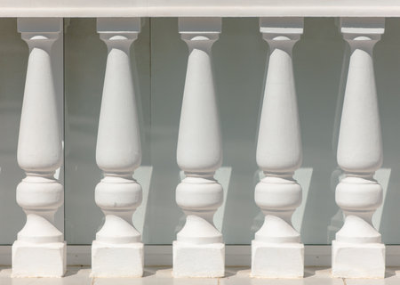 White concrete columns on the fence.