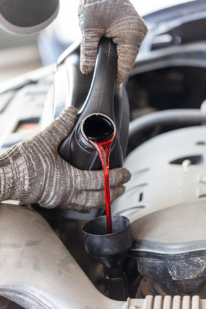 The master pours oil into the car's variator.の写真素材