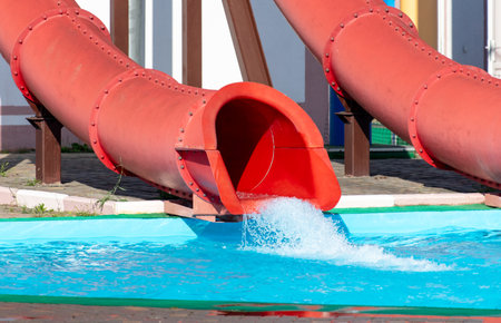 Red slide in the pool of the water park.の写真素材
