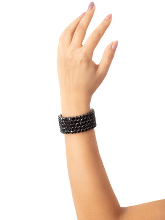 A black bracelet with precious stones is on a girl's hand.の写真素材