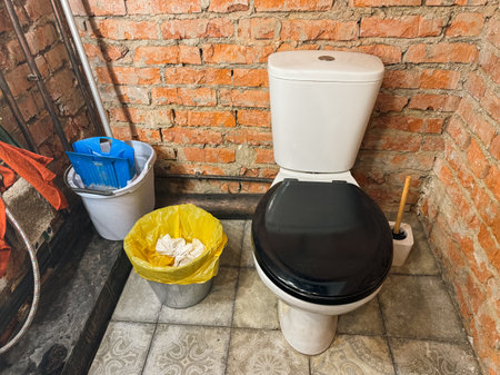 Toilet with bucket brick wall.の写真素材