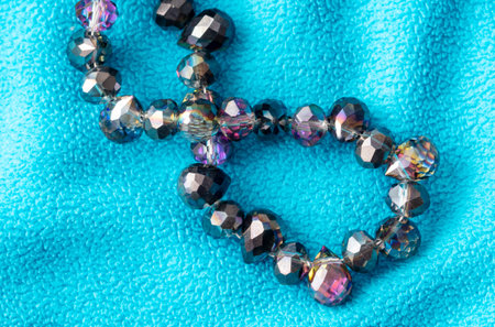 Precious stones on beads on blue fabric. Background.の写真素材