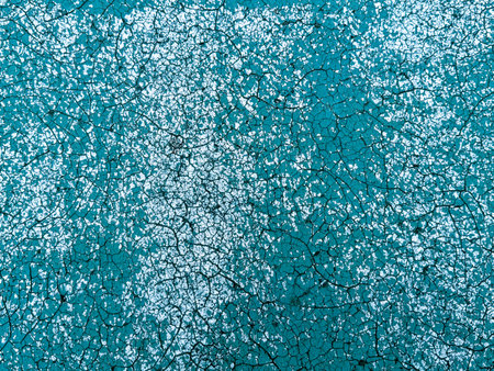 Old covering on a sports ground as an abstract background. Texture.