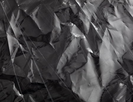 Black crumpled polyethylene as an abstract background. Texture.の写真素材