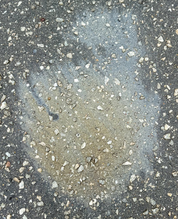A trace of gasoline on the asphalt as a background. Texture.の写真素材
