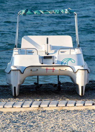 Catamarans stand on the seashore.