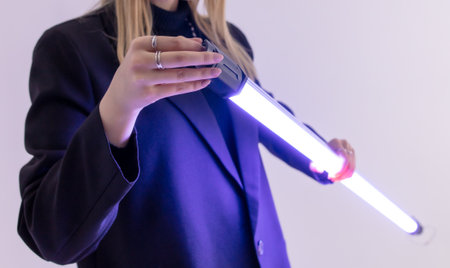A lighting device in the hands of a girl in a photo studio.の写真素材