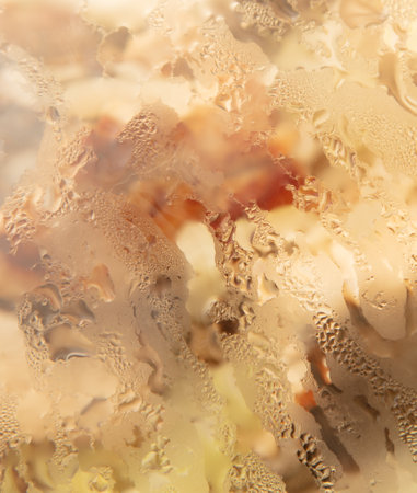 Drops of water on the glass of a frying pan as a background.