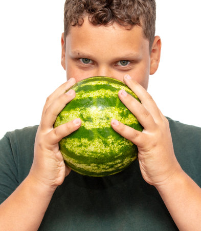 Green watermelon in the hands of a boy.の写真素材