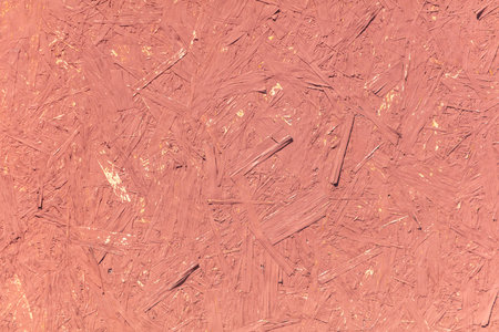 Chipboard board painted with red paint as an abstract background.の写真素材