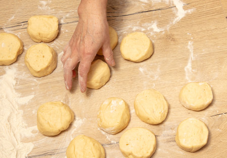 Pieces of dough on the table in flour.の写真素材