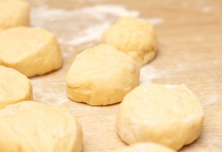 Pieces of dough on the table in flour