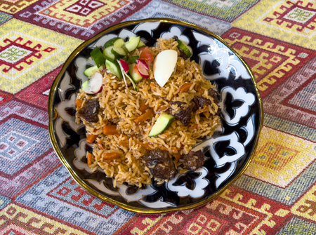 Uzbek pilaf on a plate on the table.