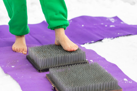 Legs of a woman standing on nails. Close-up.の写真素材
