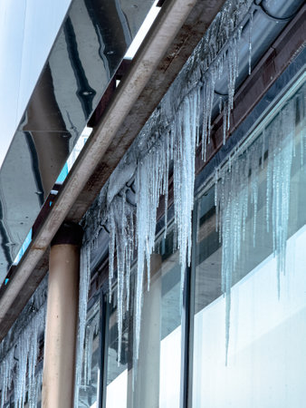 Icicles hang from a glass building.