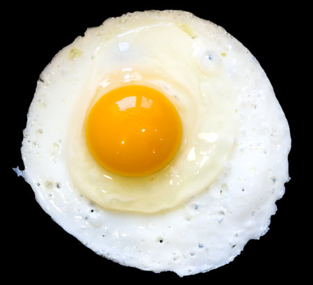 Scrambled eggs isolated on a black background.の写真素材