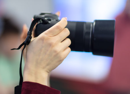 Girl photographer with a professional camera in her hands.
