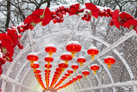 Red lanterns in the snow in the park. Chinese New Year holiday.の写真素材