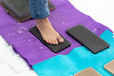 Legs of a man standing on nails. Close-up.