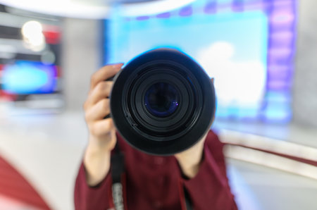 Girl photographer with a professional camera in her hands.の写真素材