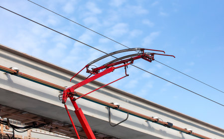 Tram wires against the blue sky.