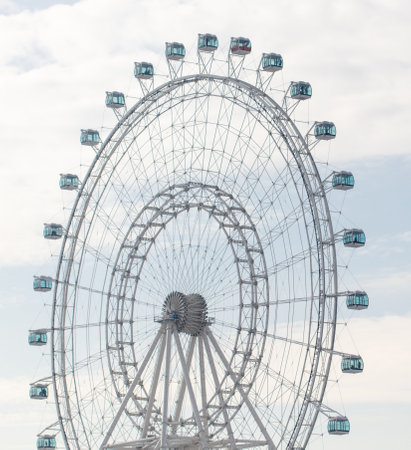 Ferris wheel on the background of the cloudy sky in the evening.の写真素材