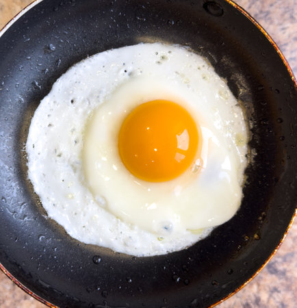 The egg is fried in a frying pan. Close-up.の写真素材