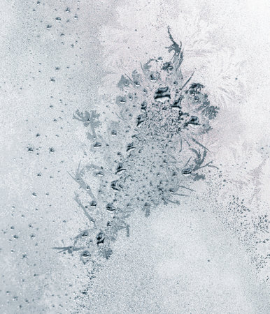 Frosty patterns on the window glass as a background.