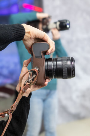 Photographer taking photo of a young man in front of the camera.