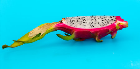 Dragon fruit in a section isolated on a blue background.の写真素材