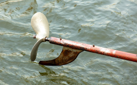 Metal propeller from a boat against the background of water.の写真素材