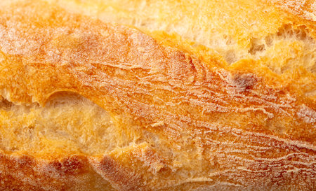 Ruddy crust of bread as an abstract background. Texture.