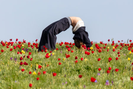 A girl makes a cartoon in a tulip field.の写真素材