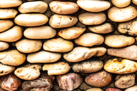 Round stones in the wall as an abstract background. Texture.の写真素材