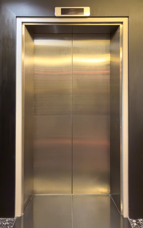 Metal door to the elevator as a background.