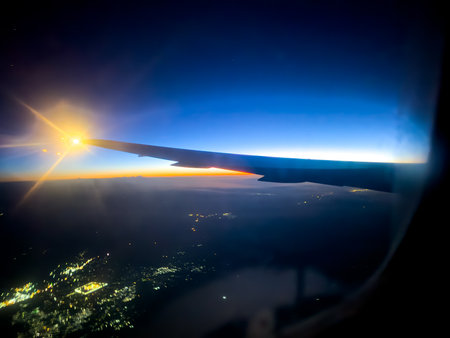 Airplane wing from the window at sunrise in the morning.
