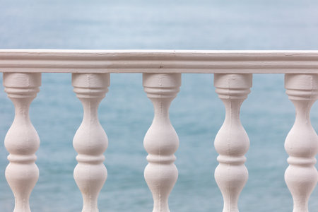 White fence with columns on the seashore.