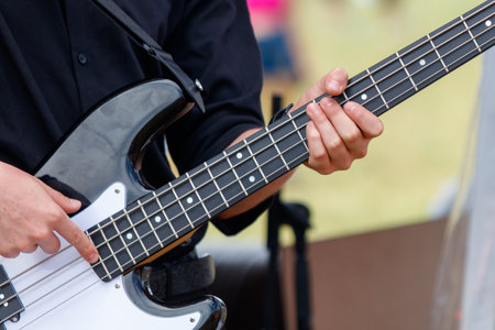 Men play the guitar. Hands close up.