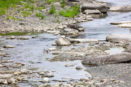 Stones and concrete slab in the river in the city.