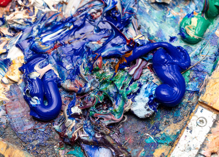 Multi-colored oil paints on the artist's table. Abstract background.
