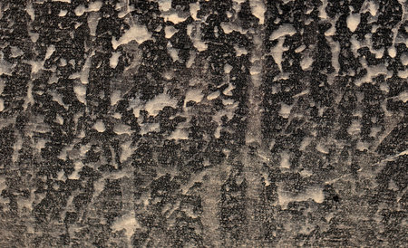 Dirt on the body of a black car. Abstract background.